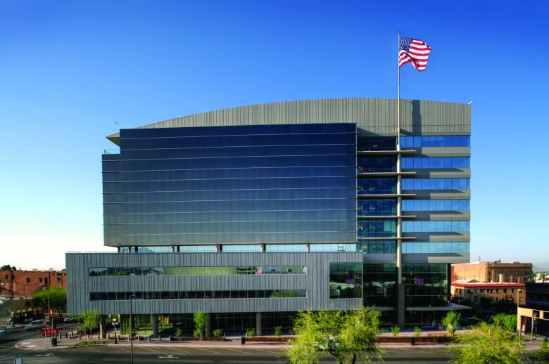 A large modern building with a curved roof designed by the architectural design team at Swaim Associates
