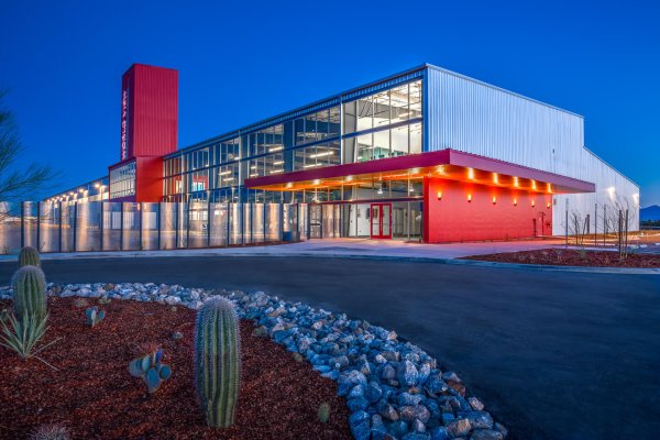 Modern architectural design on the front or a large science building with red accents on the ground floor